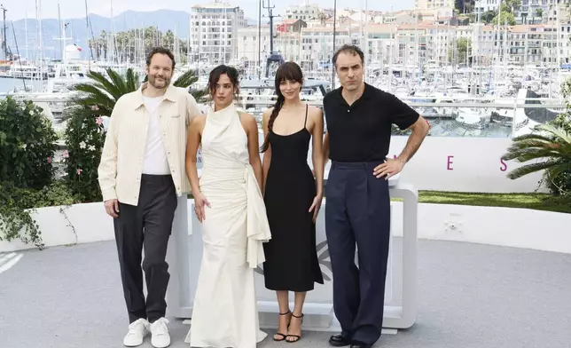 Producer Kyle Marvin, from left, Adria Arjona, Dakota Johnson and director Michael Angelo Covino pose for photographers at the photo call for the film 'Splitsville' at the 78th international film festival, Cannes, southern France, Monday, May 19, 2025. (Photo by Joel C Ryan/Invision/AP)