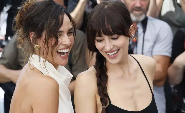 Adria Arjona, left, and Dakota Johnson pose for photographers at the photo call for the film 'Splitsville' at the 78th international film festival, Cannes, southern France, Monday, May 19, 2025. (Photo by Joel C Ryan/Invision/AP)