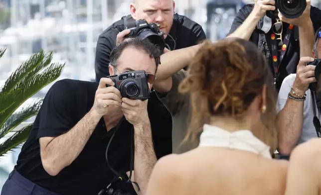 Director Michael Angelo Covino takes a photograph at the photo call for the film 'Splitsville' at the 78th international film festival, Cannes, southern France, Monday, May 19, 2025. (Photo by Joel C Ryan/Invision/AP)