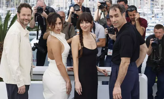 Producer Kyle Marvin, from left, Adria Arjona, Dakota Johnson and director Michael Angelo Covino pose for photographers at the photo call for the film 'Splitsville' at the 78th international film festival, Cannes, southern France, Monday, May 19, 2025. (Photo by Joel C Ryan/Invision/AP)