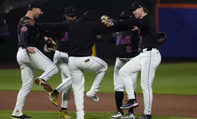 New York Mets' Brett Baty (7) celebrates iwth teammates after a baseball game against the Pittsburgh Pirates Tuesday, May 13, 2025, in New York. (AP Photo/Frank Franklin II)
