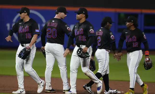 New York Mets' Francisco Lindor (12) and Juan Soto (22) celebrate with teammates Luisangel Acuña (2), Pete Alonso (20) and Tyrone Taylor (15) after a baseball game against the Pittsburgh Pirates Tuesday, May 13, 2025, in New York. (AP Photo/Frank Franklin II)