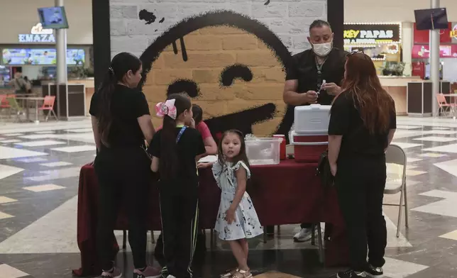 A health worker prepares a dose of the measles vaccine in shopping mall in Ciudad Juarez, Chihuahua state, Mexico, Wednesday, April 30, 2025. (AP Photo/Christian Chavez)