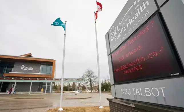A sign outside Southwestern Public Health in St. Thomas, Ontario, Canada, on Tuesday, March 4, 2025, warns residents to call ahead before visiting a doctor or hospital if they think they have the measles. (Geoff Robins/The Canadian Press via AP)