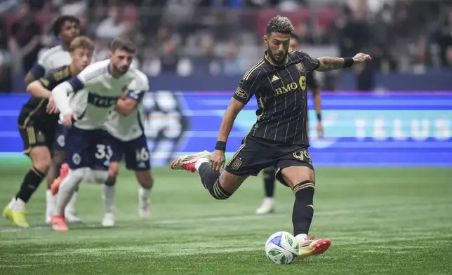 Los Angeles FC's Denis Bouanga, right, scores on a penalty kick during the first half of an MLS soccer match against the Vancouver Whitecaps in Vancouver, British Columbia, Sunday, May 11, 2025. (Darryl Dyck/The Canadian Press via AP)
