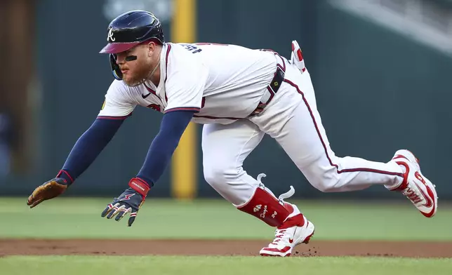 Atlanta Braves' Alex Verdugo slides into second base after a leadoff double in the first inning of a baseball game against the Washington Nationals, Monday, May 12, 2025, in Atlanta. (AP Photo/Colin Hubbard)