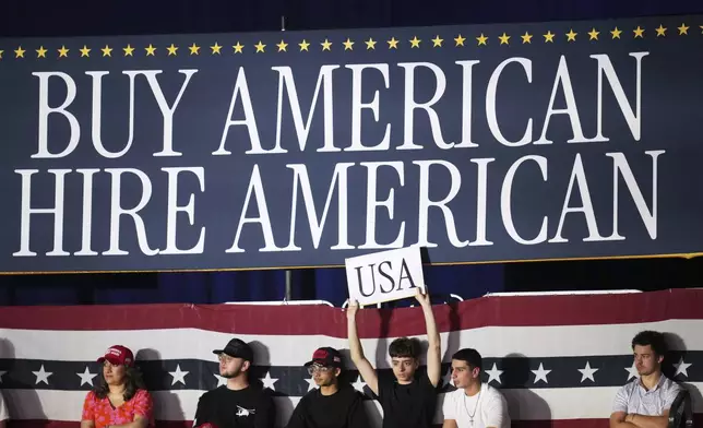 People arrive before President Donald Trump speaks on his first 100 days at Macomb County Community College Sports Expo Center, Tuesday, April 29, 2025, in Warren, Mich. (AP Photo/Paul Sancya)