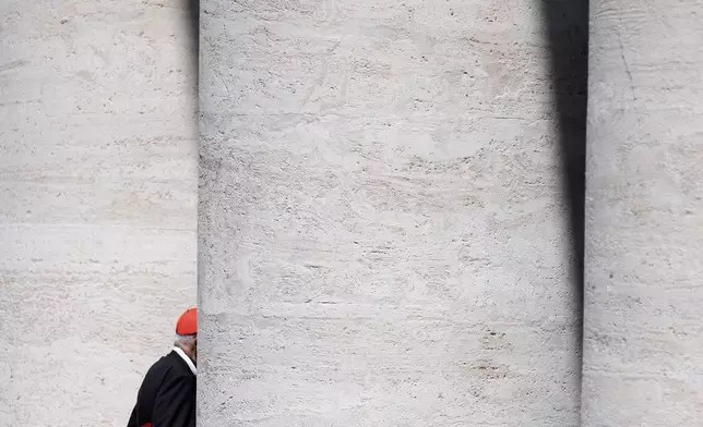 An unidentified Cardinal walks through the St. Peter's Square colonnade at the end of a college of cardinals' meeting, at the Vatican, Tuesday, April 29, 2025. (AP Photo/Gregorio Borgia)