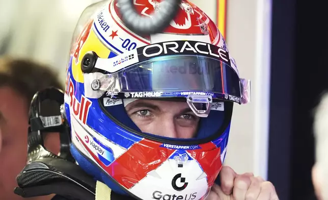 Red Bull driver Max Verstappen of the Netherlands puts on his helmet in the pits during a practice session for the Formula One Miami Grand Prix auto race, Friday, May 2, 2025, in Miami Gardens, Fla. (AP Photo/Rebecca Blackwell)
