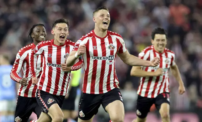 Sunderland's Daniel Ballard, center, and teammates celebrate after the final whistle against Coventry City in a Sky Bet Championship play-off semifinal, second leg soccer match at the Stadium of Light, Tuesday May 13, 2025, in Sunderland, England. (Steve Welsh/PA via AP)