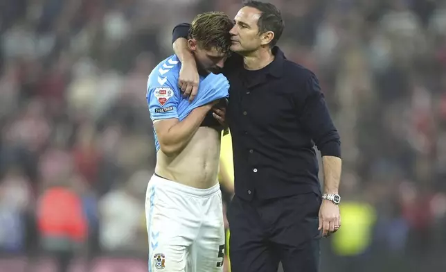 Coventry City head coach Frank Lampard, right, consoles player Jack Rudoni after losing to Sunderland in a Sky Bet Championship play-off semifinal, second leg soccer match at the Stadium of Light, Tuesday May 13, 2025, in Sunderland, England. (Owen Humphreys/PA via AP)