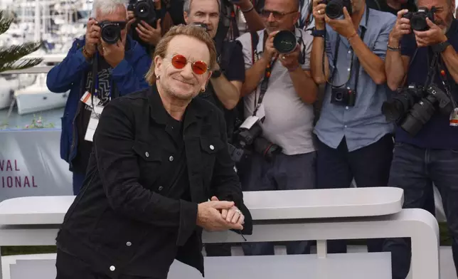 Bono poses for photographers at the photo call for the film 'Bono: Stories of Surrender' at the 78th international film festival, Cannes, southern France, Saturday, May 17, 2025. (Photo by Joel C Ryan/Invision/AP)