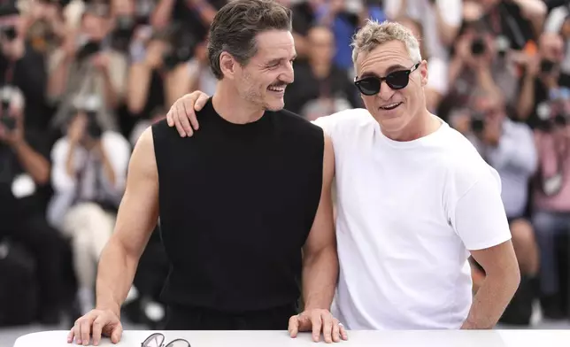 Pedro Pascal, left, and Joaquin Phoenix pose for photographers at the photo call for the film 'Eddington' at the 78th international film festival, Cannes, southern France, Saturday, May 17, 2025. (Photo by Scott A Garfitt/Invision/AP)