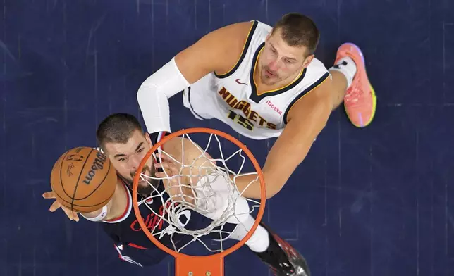 Los Angeles Clippers center Ivica Zubac, left, shoots as Denver Nuggets center Nikola Jokic defends during the first half in Game 6 of an NBA basketball first-round playoff series Thursday, May 1, 2025, in Inglewood, Calif. (AP Photo/Mark J. Terrill)