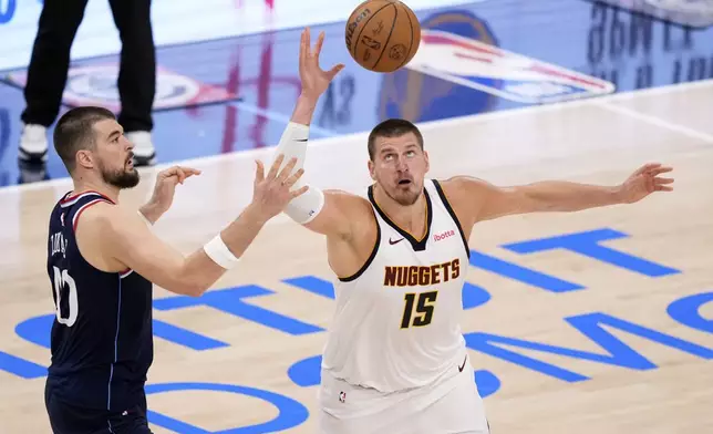 Los Angeles Clippers center Ivica Zubac,left, and Denver Nuggets center Nikola Jokic go after a loose ball during the second half in Game 6 of an NBA basketball first-round playoff series Thursday, May 1, 2025, in Inglewood, Calif. (AP Photo/Mark J. Terrill)