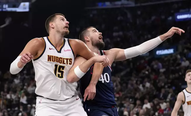 Denver Nuggets center Nikola Jokic, left, and Los Angeles Clippers center Ivica Zubac vie for a rebound during the first half in Game 6 of an NBA basketball first-round playoff series Thursday, May 1, 2025, in Inglewood, Calif. (AP Photo/Mark J. Terrill)