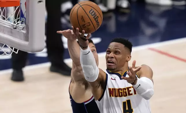 Denver Nuggets guard Russell Westbrook, right, shoots as Los Angeles Clippers guard Bogdan Bogdanovic defends during the second half in Game 6 of an NBA basketball first-round playoff series Thursday, May 1, 2025, in Inglewood, Calif. (AP Photo/Mark J. Terrill)