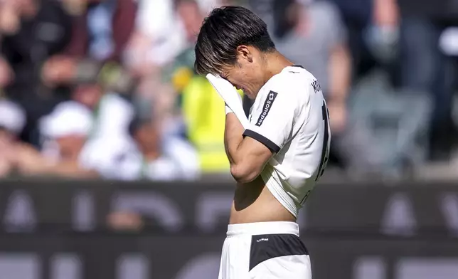 Gladbach's Shio Fukuda reacts at the end of the Bundesliga soccer match between Borussia Mönchengladbach and VfL Wolfsburg at Borussia-Park stadium, in Mönchengladbach, Germany, Saturday, May 17, 2025. (David Inderlied/dpa via AP)