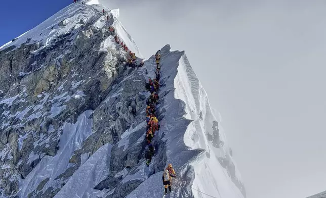 Mountaineers form a queue as they approach the summit of Mount Everest in Nepal, May 18, 2025. (AP Photo/Kunga Sherpa)