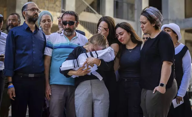 Relatives mourn as they hold the body of two-week-old Israeli infant Ravid Haim, who was delivered after his mother, Tzeela Gez, was shot and killed by a Palestinian gunman in the West Bank while en route to the hospital with her husband to give birth, in Jerusalem, Thursday, May 29, 2025. (AP Photo/Oren Ben Hakoon)