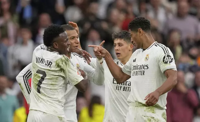Real Madrid's Kylian Mbappe, second left, celebrates with teammates after scoring his side's second goal during the Spanish La Liga soccer match between Real Madrid and Celta Vigo at the Santiago Bernabeu stadium in Madrid, Spain, Sunday, May 4, 2025. (AP Photo/Jose Breton)