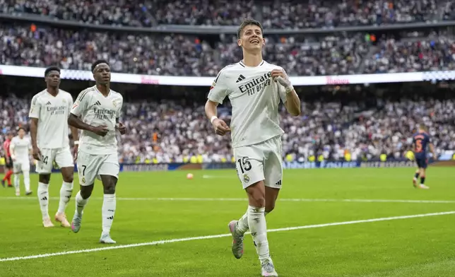 Real Madrid's Arda Guler celebrates after scoring his side's opening goal during the Spanish La Liga soccer match between Real Madrid and Celta Vigo at the Santiago Bernabeu stadium in Madrid, Spain, Sunday, May 4, 2025. (AP Photo/Jose Breton)
