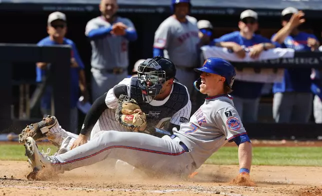 New York Mets' Brett Baty (7) reacts after being tagged out by New York Yankees catcher J.C. Escarra at home plate during the seventh inning of a baseball game, Saturday, May 17, 2025, in New York. (AP Photo/Noah K. Murray)