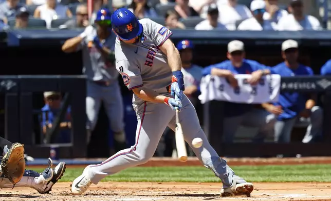 New York Mets' Pete Alonso (20) hits an RBI single scoring Francisco Lindor during the fourth inning of a baseball game against the New York Yankees, Saturday, May 17, 2025, in New York. (AP Photo/Noah K. Murray)