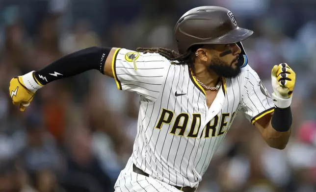 San Diego Padres' Fernando Tatis Jr. runs after hitting a single during the third inning of a baseball game against the Seattle Mariners Friday, May 16, 2025, in San Diego. (AP Photo/Brandon Sloter)
