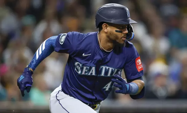 Seattle Mariners' Julio Rodriguez singles during the sixth inning of a baseball game against the San Diego Padres, Friday, May 16, 2025, in San Diego. (AP Photo/Brandon Sloter)
