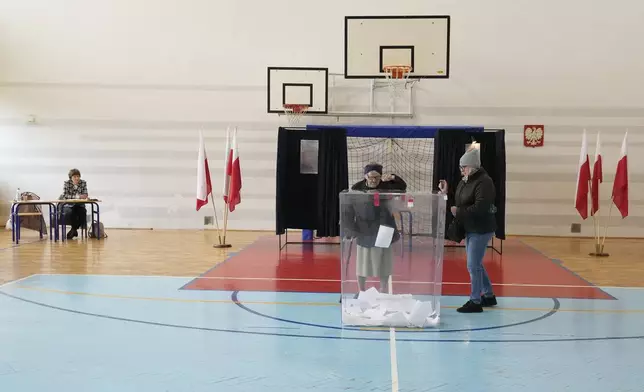 Voters cast their ballots polling stations opened in the first round of Poland's presidential elections in Lomianki, near Warsaw, on Sunday, May 18, 2025. (AP Photo/Czarek Sokolowski)