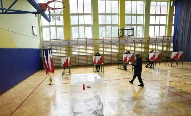 Voters cast their ballots polling stations opened in the first round of Poland's presidential elections in Warsaw, on Sunday, May 18, 2025. (AP Photo/Czarek Sokolowski)