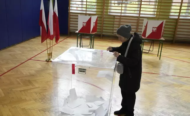 Voters cast their ballots polling stations opened in the first round of Poland's presidential elections in Warsaw, on Sunday, May 18, 2025. (AP Photo/Czarek Sokolowski)