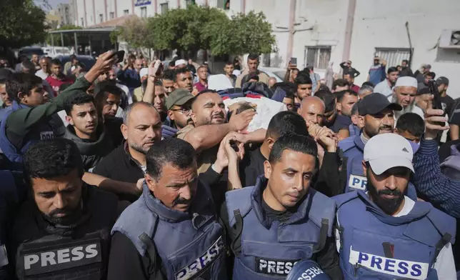 ADDS CONTEXT.- Mourners carry the body of Palestinian journalist Hassan Eslaiah, who was killed in an overnight Israeli strike on Nasser Hospital, with the Israeli military claiming he was targeted for being a Hamas militant involved in the October 7, 2023, attack on southern Israel that sparked the war, in Khan Younis, southern Gaza Strip, Tuesday, May 13. (AP Photo/Jehad Alshrafi)