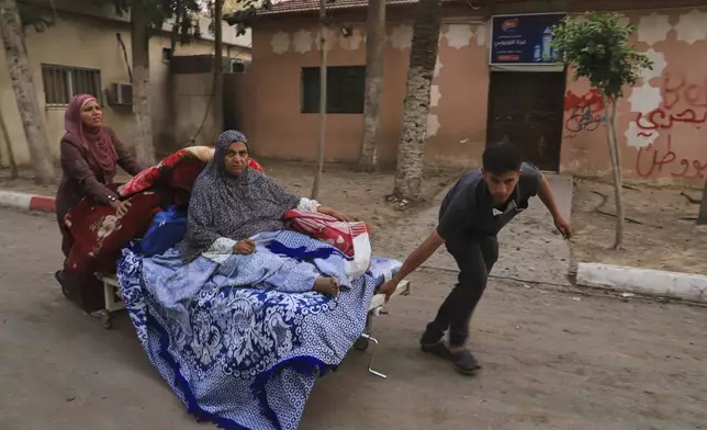 Palestinians evacuate patients from the European hospital in Khan Younis, Gaza, after it was hit by an Israeli army airstrike, Tuesday, May 13, 2025. The Israeli military said it had carried out a strike targeting what it said was a Hamas "command and control center" located beneath the hospital. (AP Photo/Mariam Dagga)