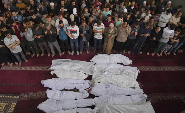 Mourners pray over the bodies of Palestinians killed in an Israeli military airstrike that hit a U.N. school, during a funeral in Jabaliya, northern Gaza Strip, on Monday, May 12, 2025. (AP Photo/Jehad Alshrafi6