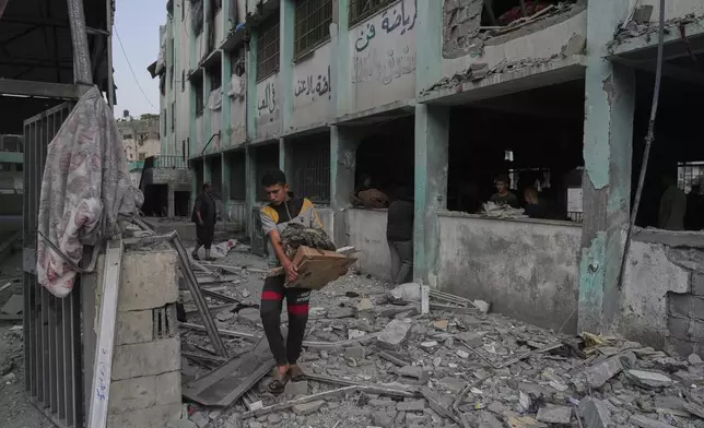 Palestinians inspect the damage at a U.N. school used as a shelter by displaced residents that was hit by Israeli military strikes, killing more than 15 people, in Jabaliya, northern Gaza Strip, on Monday, May 12, 2025. (AP Photo/Jehad Alshrafi)