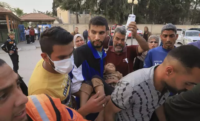 Palestinians evacuate patients from the European hospital in Khan Younis, Gaza, after it was hit by an Israeli army airstrike, Tuesday, May 13, 2025. The Israeli military said it had carried out a strike targeting what it said was a Hamas "command and control center" located beneath the hospital. (AP Photo/Mariam Dagga)