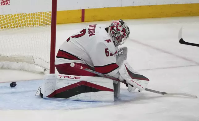 The puck gets past Carolina Hurricanes goaltender Pyotr Kochetkov on a goal scored by Florida Panthers defenseman Niko Mikkola during the third period in Game 3 of the NHL hockey Stanley Cup Eastern Conference finals Saturday, May 24, 2025, in Sunrise, Fla. (AP Photo/Lynne Sladky)