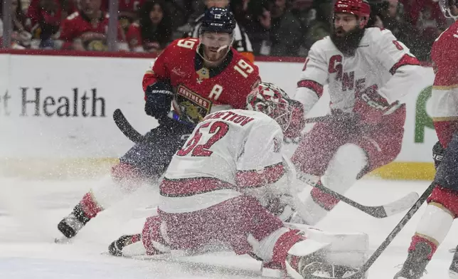 Carolina Hurricanes goaltender Pyotr Kochetkov (52) defends the goal against Florida Panthers left wing Matthew Tkachuk (19) during the second period in Game 3 of the NHL hockey Stanley Cup Eastern Conference finals Saturday, May 24, 2025, in Sunrise, Fla. (AP Photo/Lynne Sladky)