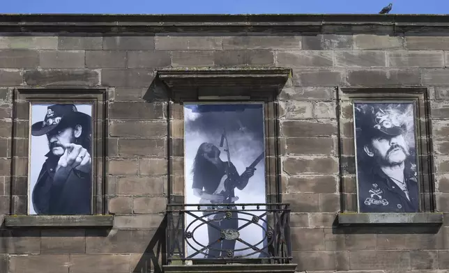 Windows of a house are covered with posters of singer Lemmy Kilmister to commemorate the Motorhead frontman in Burslem, Stoke on Trent, England, Friday, May 9, 2025. The musician, once described as having 'one of the most recognizable voices in rock', was born in Burslem and a statue has been crafted by acclaimed local sculptor and lifelong Motorhead fan Andy Edwards. (AP Photo/Kirsty Wigglesworth)