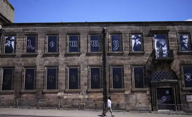 Windows of a house are covered with posters of singer Lemmy Kilmister to commemorate the Motorhead frontman in Burslem, Stoke on Trent, England, Friday, May 9, 2025. The musician, once described as having 'one of the most recognizable voices in rock', was born in Burslem and a statue has been crafted by acclaimed local sculptor and lifelong Motorhead fan Andy Edwards. (AP Photo/Kirsty Wigglesworth)