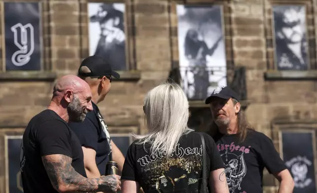 Motorhead fans gather to commemorate Lemmy Kilmister the Motorhead frontman in Burslem, Stoke on Trent, England, Friday, May 9, 2025. The musician, once described as having 'one of the most recognizable voices in rock', was born in Burslem and a statue has been crafted by acclaimed local sculptor and lifelong Motorhead fan Andy Edwards. (AP Photo/Kirsty Wigglesworth)