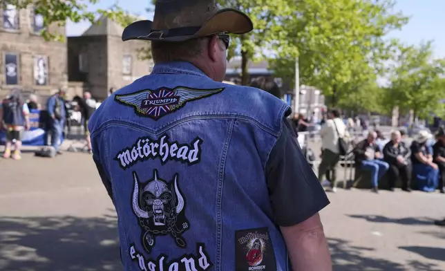 Motorhead fans gather to commemorate Lemmy Kilmister the Motorhead frontman in Burslem, Stoke on Trent, England, Friday, May 9, 2025. The musician, once described as having 'one of the most recognizable voices in rock', was born in Burslem and a statue has been crafted by acclaimed local sculptor and lifelong Motorhead fan Andy Edwards. (AP Photo/Kirsty Wigglesworth)
