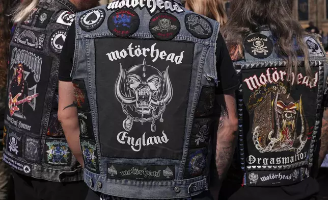 Motorhead fans gather to commemorate Lemmy Kilmister the Motorhead frontman in Burslem, Stoke on Trent, England, Friday, May 9, 2025. The musician, once described as having 'one of the most recognizable voices in rock', was born in Burslem and a statue has been crafted by acclaimed local sculptor and lifelong Motorhead fan Andy Edwards. (AP Photo/Kirsty Wigglesworth)