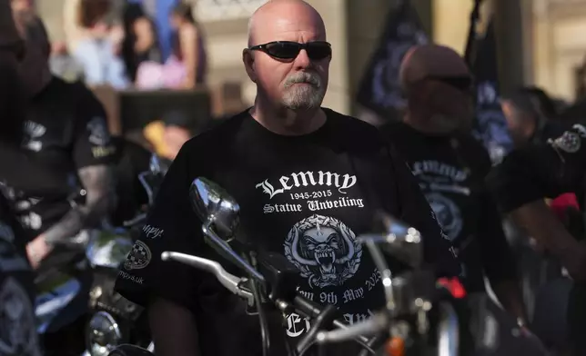A biker is wearing a Motorhead T-Shirt as fans gather to commemorate Lemmy Kilmister the Motorhead frontman in Burslem, Stoke on Trent, England, Friday, May 9, 2025. The musician, once described as having 'one of the most recognizable voices in rock', was born in Burslem and a statue has been crafted by acclaimed local sculptor and lifelong Motorhead fan Andy Edwards. (AP Photo/Kirsty Wigglesworth)