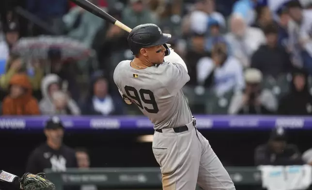 New York Yankees' Aaron Judge follows the flight of his RBI double off Colorado Rockies relief pitcher Jake Bird in the top of the fifth inning of a baseball game Sunday, May 25, 2025, in Denver. (AP Photo/David Zalubowski)