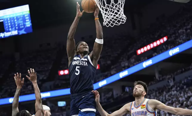 Minnesota Timberwolves guard Anthony Edwards (5) shoots against Oklahoma City Thunder forward Chet Holmgren, bottom right, during the second half of Game 4 of the Western Conference finals of the NBA basketball playoffs Monday, May 26, 2025, in Minneapolis. (AP Photo/Abbie Parr)