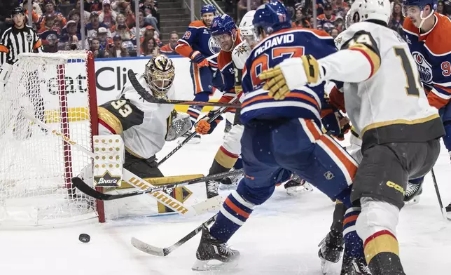 Vegas Golden Knights goalie Adin Hill (33) makes a save against Edmonton Oilers' Connor McDavid (97) during the second period of Game 3 of a second-round NHL hockey playoff series in Edmonton, Alberta, Saturday, May 10, 2025. (Jason Franson/The Canadian Press via AP)