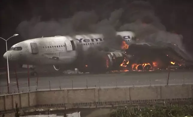 This frame grab from a handout video provided by the Ansar Allah Media Office shows smoke billowing from civilian aircraft following Israeli airstrikes on Sanaa International Airport in Sanaa, Yemen, Tuesday, May 6, 2025.(Courtesy of Ansar Allah Media Office via AP)